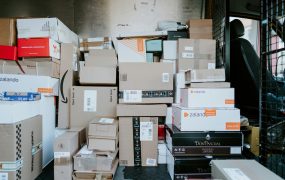 brown cardboard boxes on black plastic crate